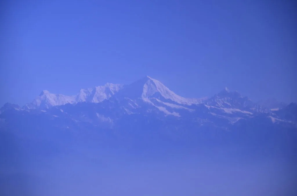 Snow-covered mountain range against clear blue sky
